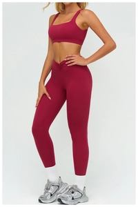Close-up of V-shaped crossover waist detail on burgundy yoga leggings with high elasticity