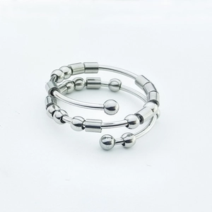 Macro shot of silver fidget ring with sliding beads and spiral stainless steel structure