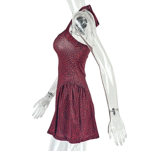 Side view of halter neck dress with red floral print and flared hem on a mannequin