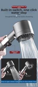 Detail view of pressurized matte grey shower head showing one-key stop button and fine nozzles