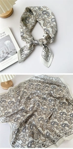 Detail of paisley silk scarf styled on book with elegant beige pattern and soft texture