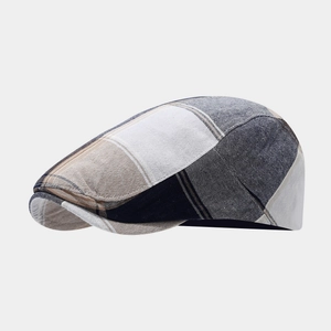 Close-up of the vintage plaid flat cap fabric showing detailed weave and texture