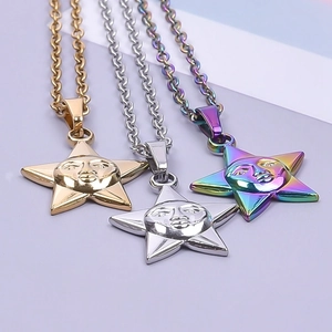 Close-up of gold, silver, and rainbow steel star pendants with facial expressions