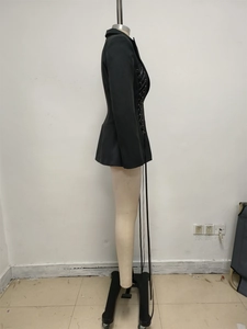 Detail of a dark style blazer dress featuring metal eyelets and side lace-up tie design