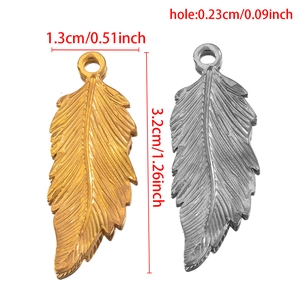 Retro stainless steel feather charms in gold and silver with dimensions 3.2cm x 1.3cm