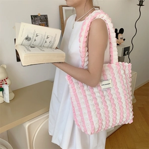 Close-up of pink bubble texture tote bag with LOVE SOZAKKA woven label and stripe pattern