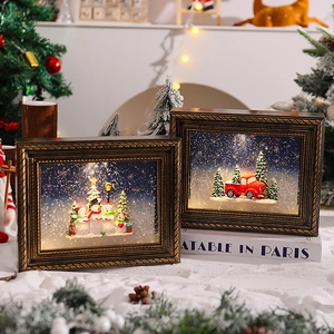 Detail of vintage Christmas frame decorations with glowing snowy scenes and LED lights