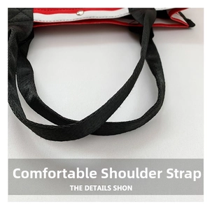 Close-up of durable black woven shoulder straps and tri-color canvas patchwork bag detail