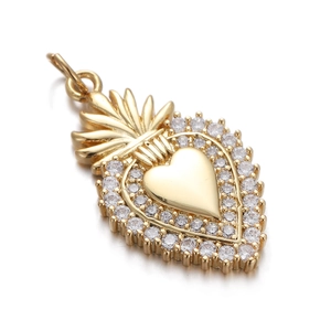 Detailed view of heart-shaped gold pendant featuring crown detail and pave-set zircons