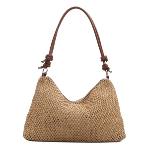 Minimalist straw woven crossbody bag with brown leather knotted strap for summer beach vacation