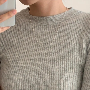 Minimalist 925 sterling silver beaded chain necklace worn on a grey knit sweater