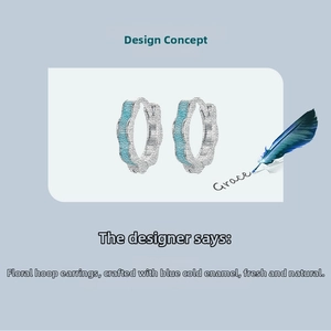 Detail of s925 silver flower hoop earrings with blue cold enamel design details