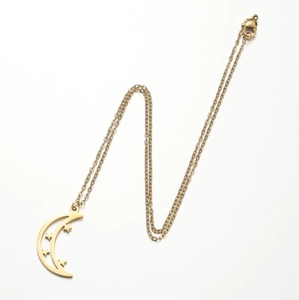 Detailed top view of gold crescent moon pendant with star cutouts on a fine chain