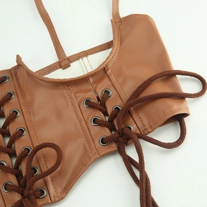 Detail of brown faux leather corset top with metal eyelets and thick lace-up front design