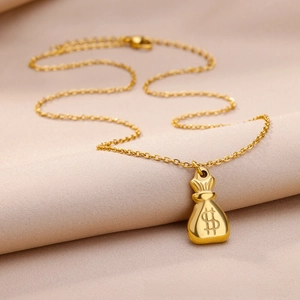 Macro detail of 18k gold plated money bag pendant with dollar sign on stainless steel chain