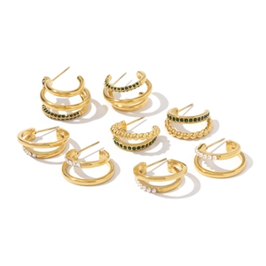 Detail view of 18K gold-plated multi-layer earrings with green crystals and pearls