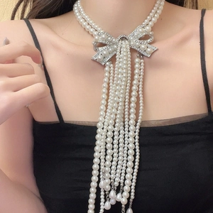 Luxurious multi-layer pearl necklace with rhinestone bow and long tassel for bridal wear