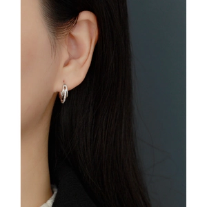 Close-up of S925 sterling silver interlocking double hoop earrings with pave diamonds