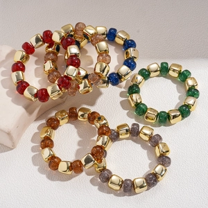 Retro geometric acrylic beaded bracelets with gold square accents on a white textured base