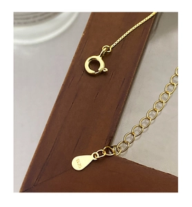 Close-up of S925 sterling silver spring clasp and teardrop tag on gold pearl necklace