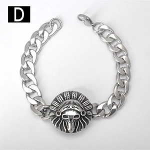 Detail of a vintage silver Cuban link bracelet featuring a tribal skull medallion clasp