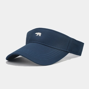 Detail shot of navy blue sun visor with small white bear embroidery on crown