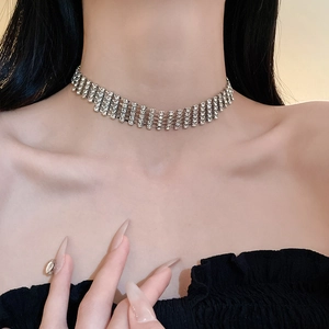 Close-up of luxury silver choker with rows of sparkling rhinestones on model neck