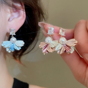 Close-up of fan-shaped petal earrings with cubic zirconia and pearls in blue and pink