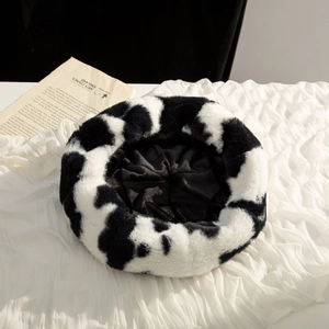 Chic black and white cow print plush beret made of soft faux fur for winter warmth