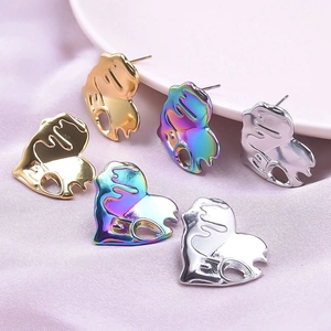 Detailed view of irregular heart earrings in polished gold, silver, and rainbow steel