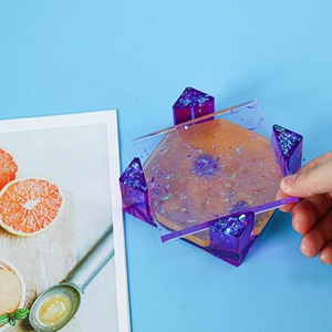 Detail of DIY epoxy resin coaster molds set with purple laser glitter finish