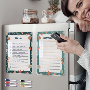 Magnetic acrylic weekly planner with colored markers shown on a stainless steel fridge