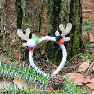 Christmas reindeer antler headband with golden glitter horns and red white fuzzy pom-poms