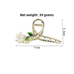 Detail view of gold flower hair claw with 11cm length and 39g net weight specifications