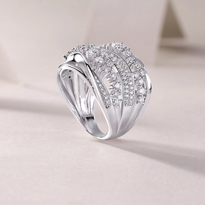 Macro shot of multilayer criss-cross silver ring with shimmering pave-set crystals