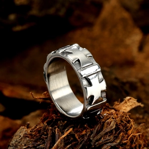 Vintage silver metal wide band ring with engraved cross flower pattern on rustic wood bark