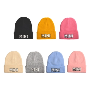 Detail view of seven colorful knit beanies with MINI embroidery and ribbed fold-over cuffs