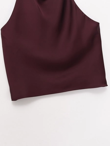 Detailed view of burgundy satin halter top showing smooth glossy fabric and elegant drape