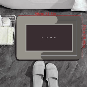 Detail view of 80x50cm grey diatom mud bath mat with HOME text on marble floor