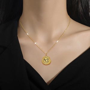 Minimalist gold butterfly elephant necklace for women with a round pendant on the neck
