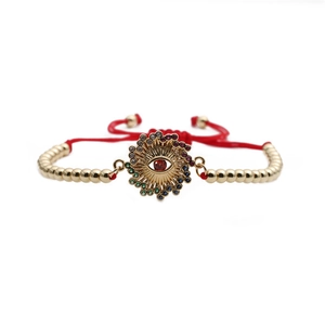Bracelet œil porte-bonheur avec zircons colorés, perles dorées et cordon rouge ajustable