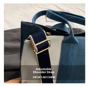 Detail showing the adjustable shoulder strap and golden metal buckle on denim canvas tote