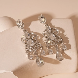 Macro shot of silver drop earrings with shimmering crystals and pear-cut stones
