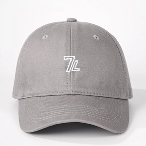Close-up of gray cotton baseball cap with white 7L embroidery and twill texture details
