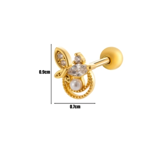 Macro shot of gold butterfly stud earring with inlaid pearls and sparkling cubic zirconia