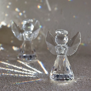 Macro shot of faceted crystal angel figurine with iridescent light refraction and star