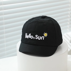 Detailed close-up of the Hello Sun embroidery on this black cotton baby baseball cap