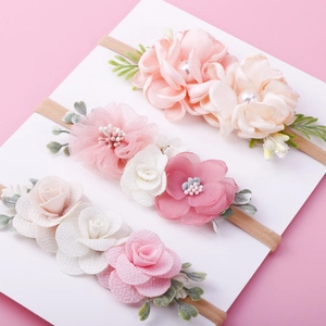 Detailed set of three floral baby headbands featuring soft nylon and fabric flower accents