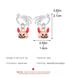 Macro shot of Halloween ghost hand and red horned pumpkin stud earrings with dimensions