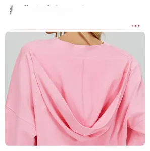 Detailed view of pink hooded sweatshirt with drop shoulder seams and premium knit fabric